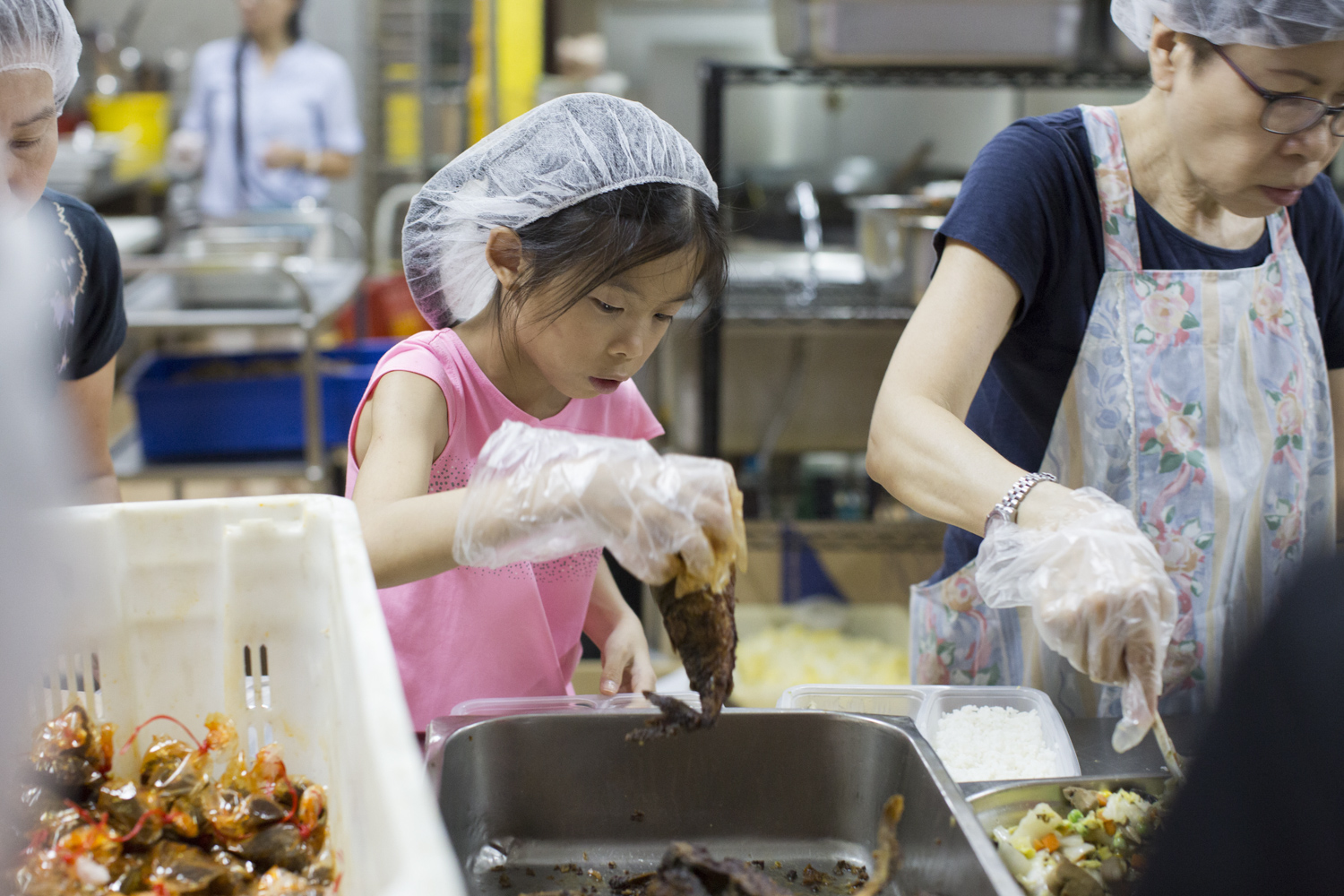 She packs fried fish and chilli in boxes of rice and vegetables for meal recipients, who are often elderly people that are physically immobile.