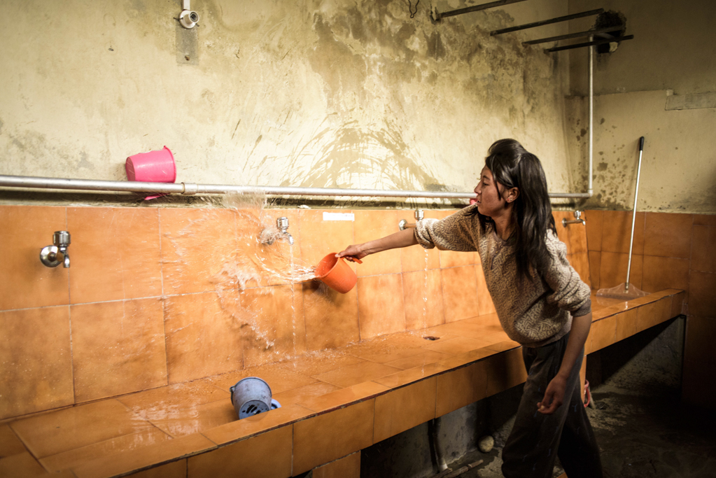 Dolma helps clean the bathrooms. Students actively volunteer to help out with different jobs - from watering plants, to cleaning bathrooms, to milking cows.