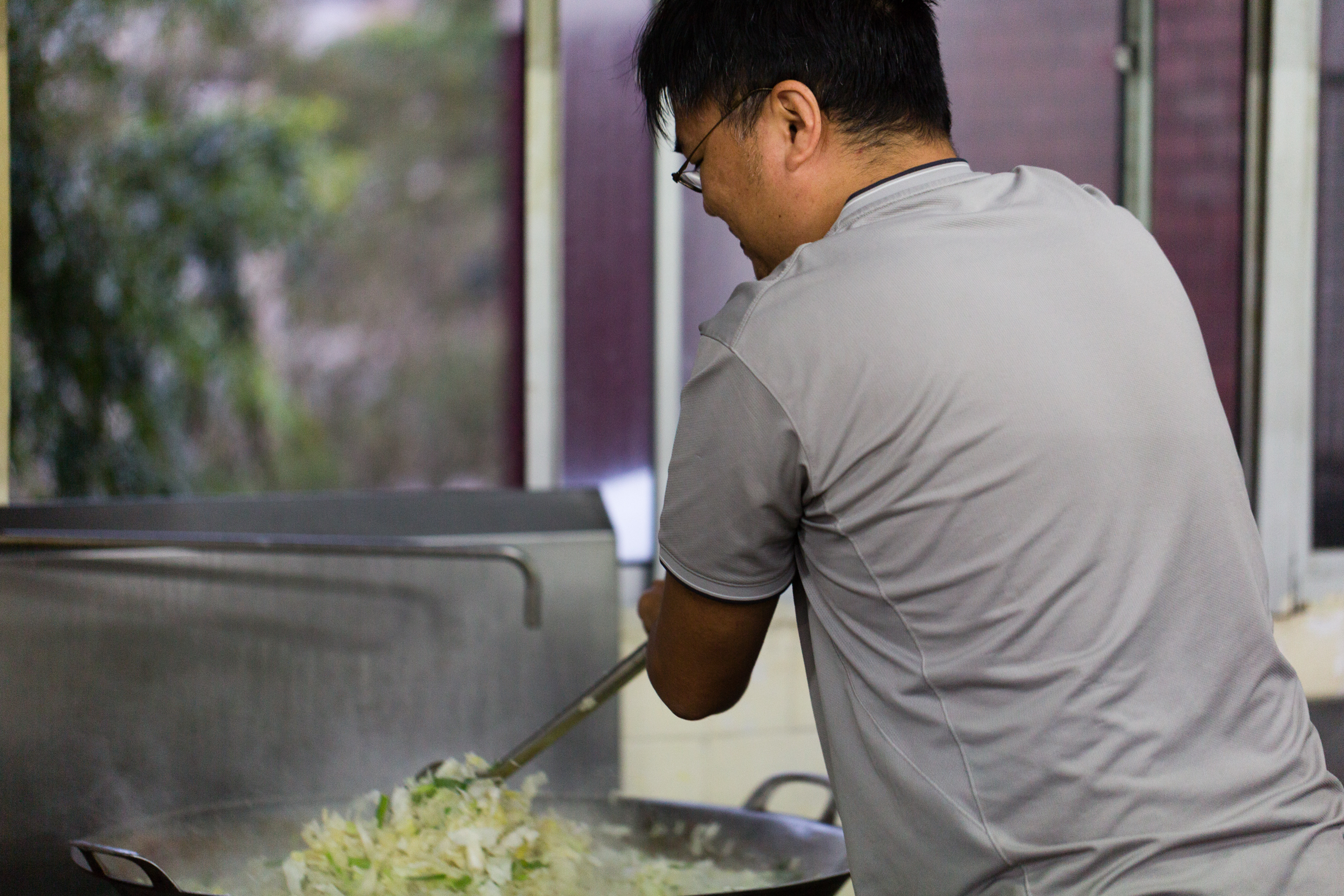 Josh then wields the giant spatula, cooking kilogram after kilogram of greens