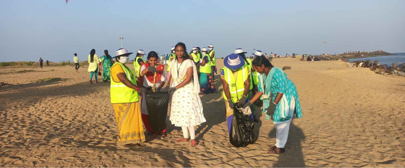 Picking litter along the beach 